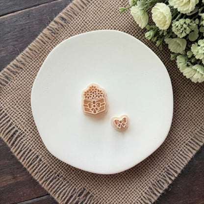 floral book and bow clay cutters on white plate