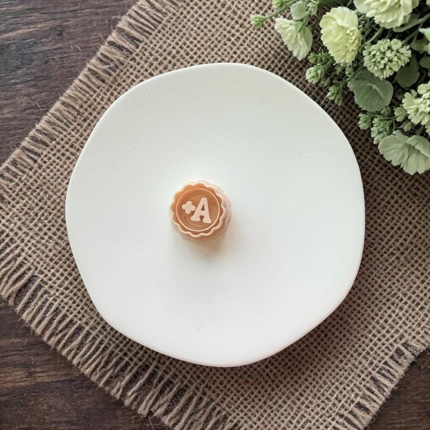 A plus clay cutter on white plate with neutral styling
