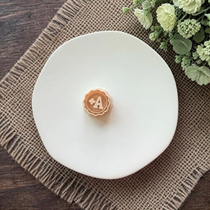 A plus clay cutter on white plate with neutral styling