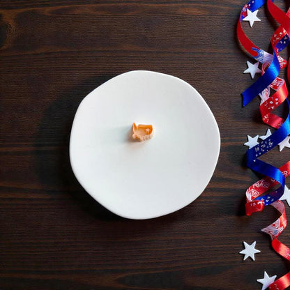 Small USA map polymer clay cutter displayed on white clay surface with patriotic ribbon and stars
