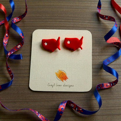Handmade patriotic USA map stud earrings displayed on jewelry card with festive red white and blue ribbon decorations