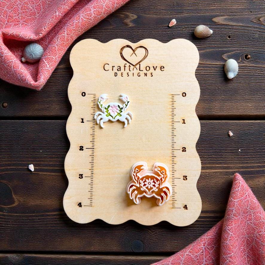 Folk art crab polymer clay cutter and finished floral crab clay earring displayed on CraftLove Designs measurement board
