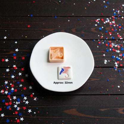 Patriotic stingray clay cutter with finished Americana stingray clay piece displayed on white ceramic plate with approximate 32mm size text