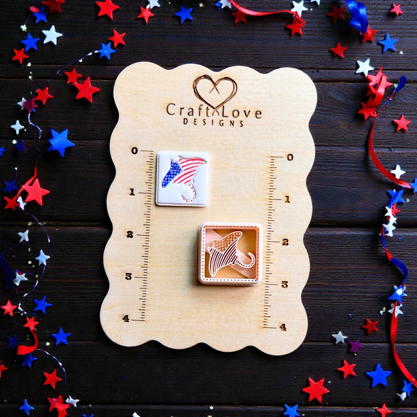 Patriotic stingray polymer clay cutter and finished clay design displayed on CraftLove Designs wooden measurement board with Fourth of July decorations