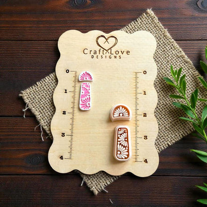Boho daisy polymer clay cutter set displayed on CraftLove Designs wooden measurement board with burlap fabric and greenery accents