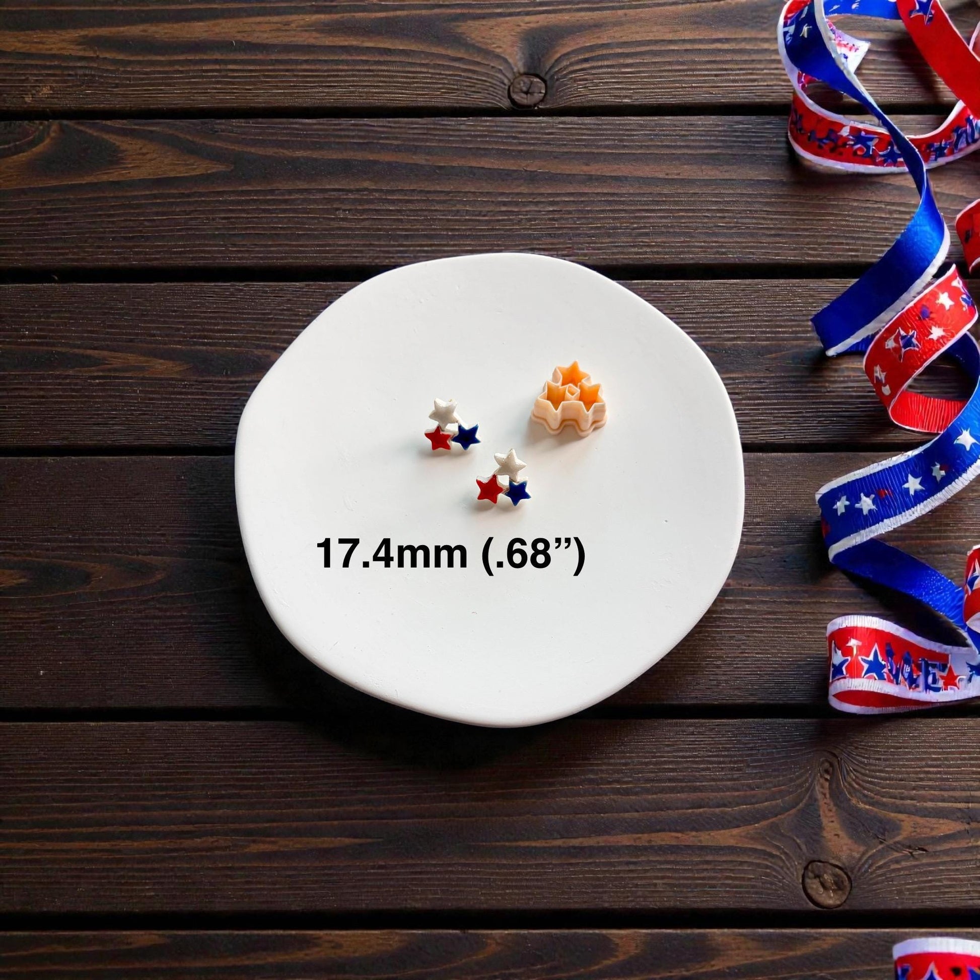 Triple star polymer clay cutter shown beside patriotic stud earrings with 17.4mm size text