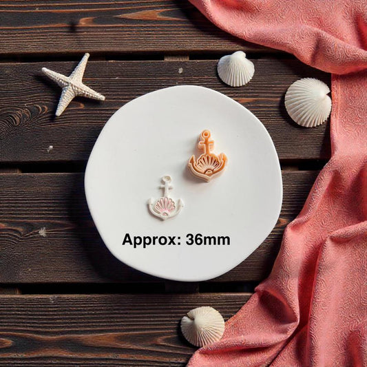 Seashell anchor polymer clay cutter measuring approximately 36mm displayed beside finished nautical clay earring piece