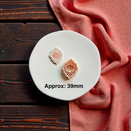 Seashell polymer clay cutter and finished shell earring shown together with approximate 39mm sizing text on white ceramic plate