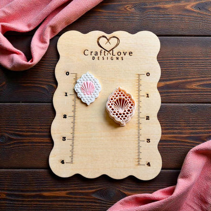 Seashell polymer clay cutter and finished shell clay earring displayed on CraftLove Designs measurement board for size comparison