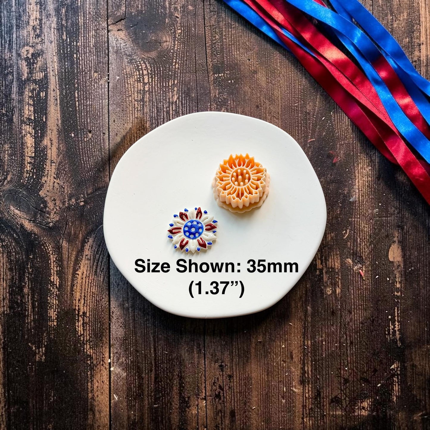 Patriotic sunflower polymer clay cutter beside finished clay example showing 35mm size measurement on a white ceramic plate