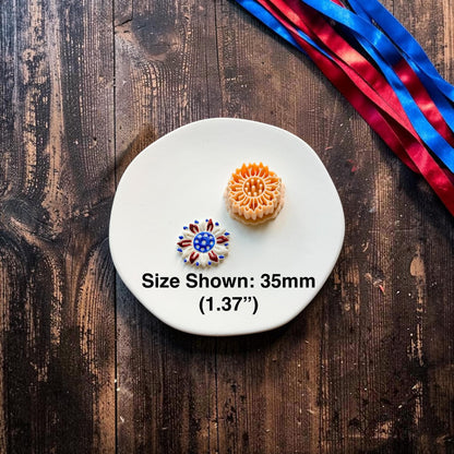 Patriotic sunflower polymer clay cutter beside finished clay example showing 35mm size measurement on a white ceramic plate