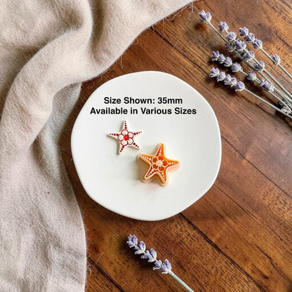 Finished starfish clay earring beside the matching cutter with text showing the 35mm size and that additional sizes are available.