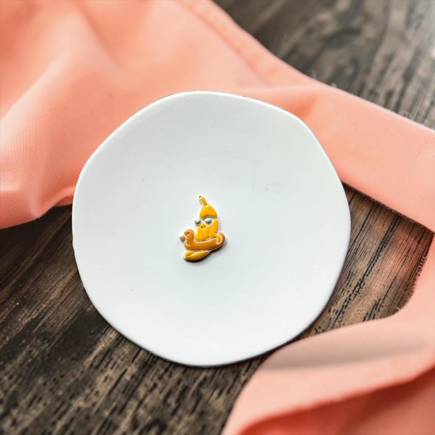 Colorful banana pool float clay piece on white plate