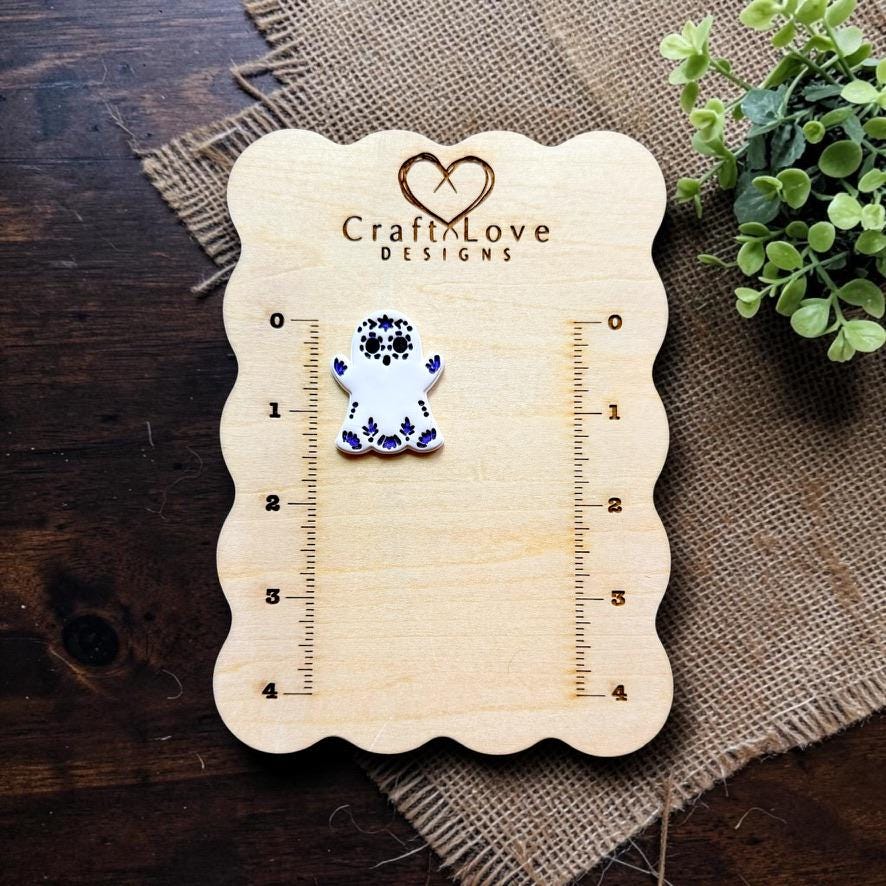 Sugar skull ghost polymer clay cutter displayed beside embossed sample on Craft Love Designs measurement board.