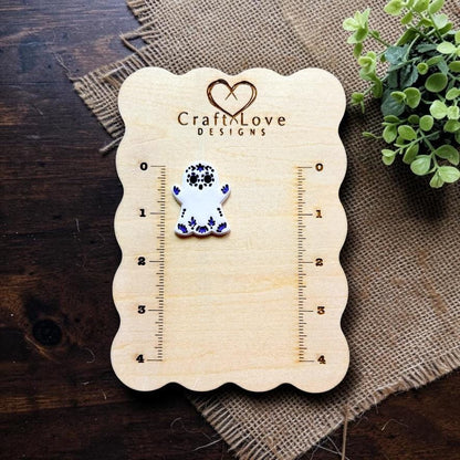 Sugar skull ghost polymer clay cutter displayed beside embossed sample on Craft Love Designs measurement board.