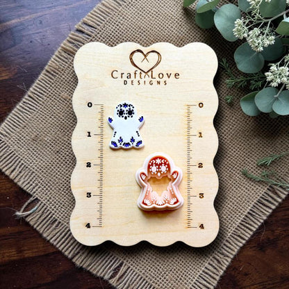 Sugar skull ghost polymer clay cutter displayed beside embossed sample on Craft Love Designs measurement board.