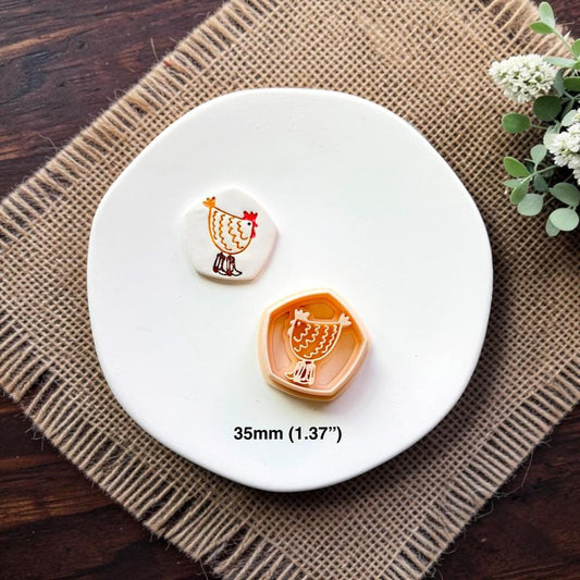 Chicken polymer clay cutter and embossed sample displayed together on a white ceramic dish showing the 35mm (1.37") size.