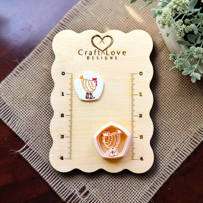 Chicken polymer clay cutter and embossed sample displayed together on the Craft Love Designs measurement board.