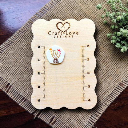 Chicken polymer clay embossed sample displayed on the Craft Love Designs measurement board.