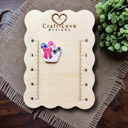 Finished summer handbag polymer clay earring displayed on the Craft Love Designs measurement board.