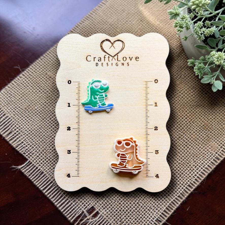 Finished skateboarding gator clay piece and matching polymer clay cutter displayed together on a Craft Love Designs measurement board.
