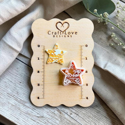 Finished beach scene polymer clay earring and matching cutter displayed on a CraftyLove Designs sizing board