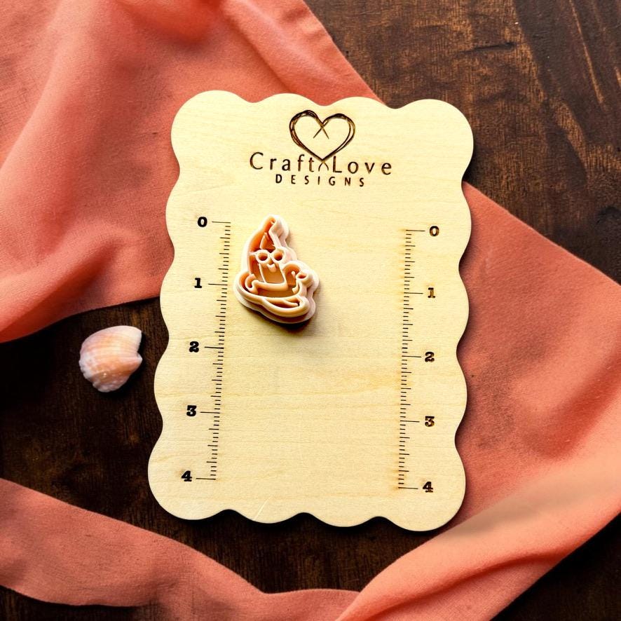 Banana pool float clay piece and matching cutter on Craft Love Designs sizing board