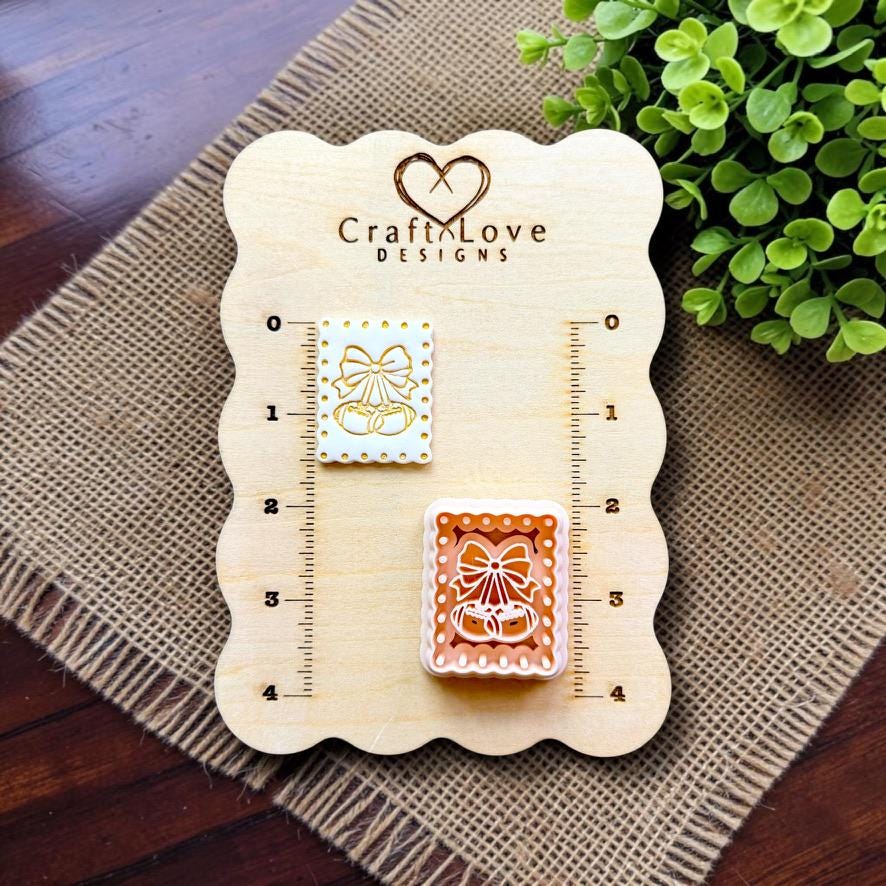 Football cherry polymer clay cutter beside embossed sample on Craft Love Designs display board.