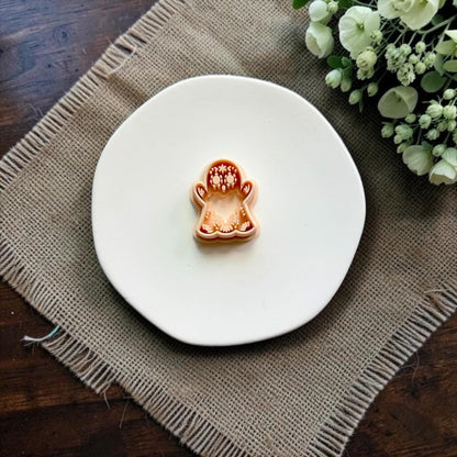 Sugar skull ghost polymer clay cutter on white ceramic dish.