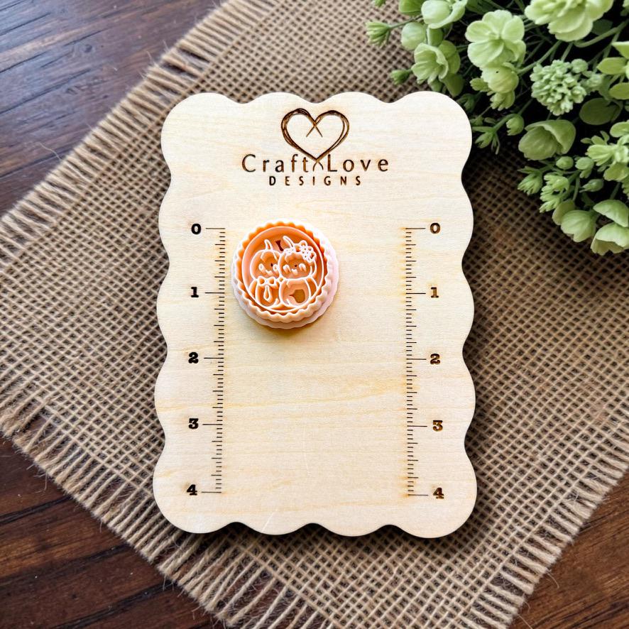 Mr and Mrs Pumpkin polymer clay cutter displayed on the Craft Love Designs measurement board.