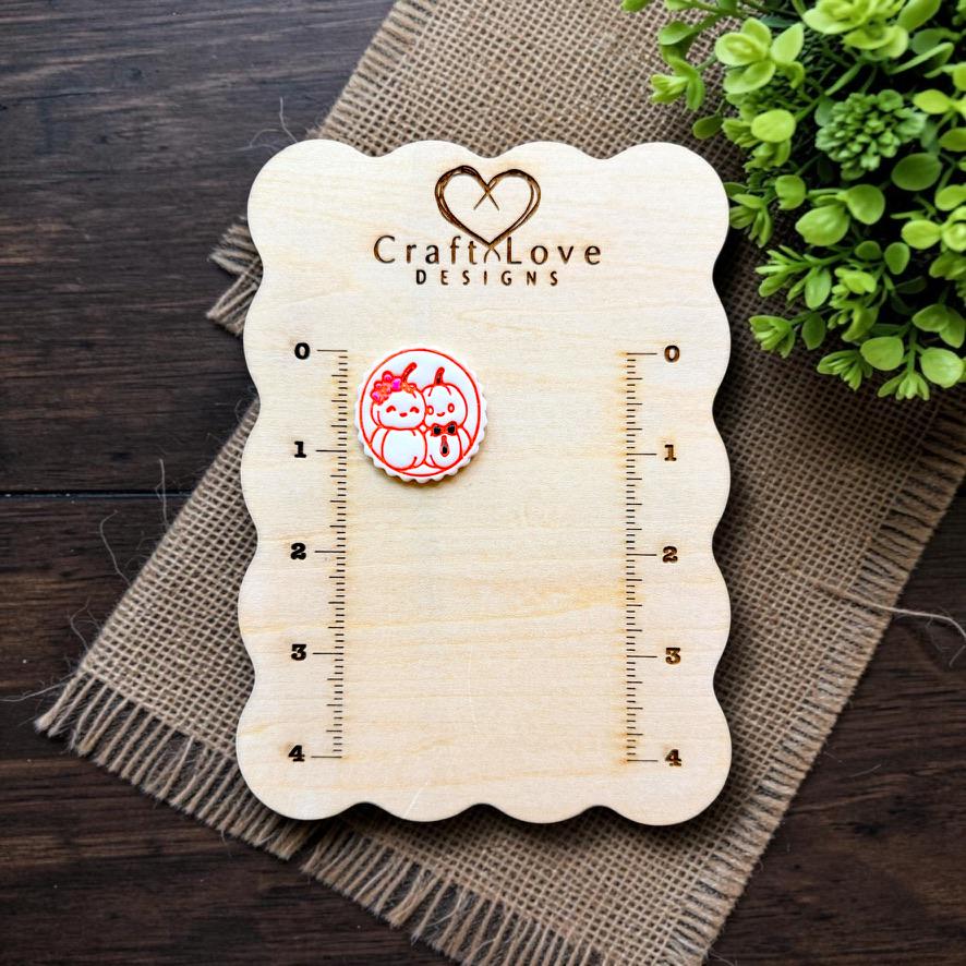 Mr and Mrs Pumpkin polymer clay cutter displayed on the Craft Love Designs measurement board.
