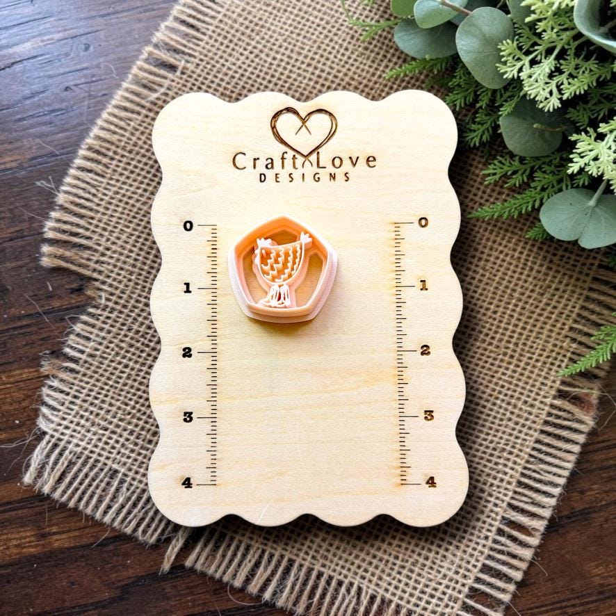 Chicken polymer clay cutter displayed on the Craft Love Designs measurement board.