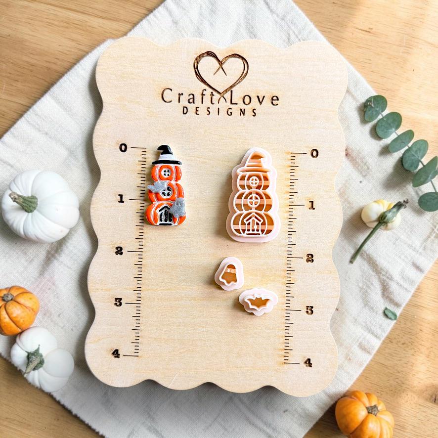 Finished stacked pumpkin Halloween design beside the matching polymer clay cutter set with separate ghost and bat pieces on a measurement board.