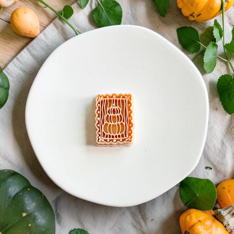 Rectangular polymer clay cutter featuring a detailed design of three vertically stacked pumpkins with a decorative border.