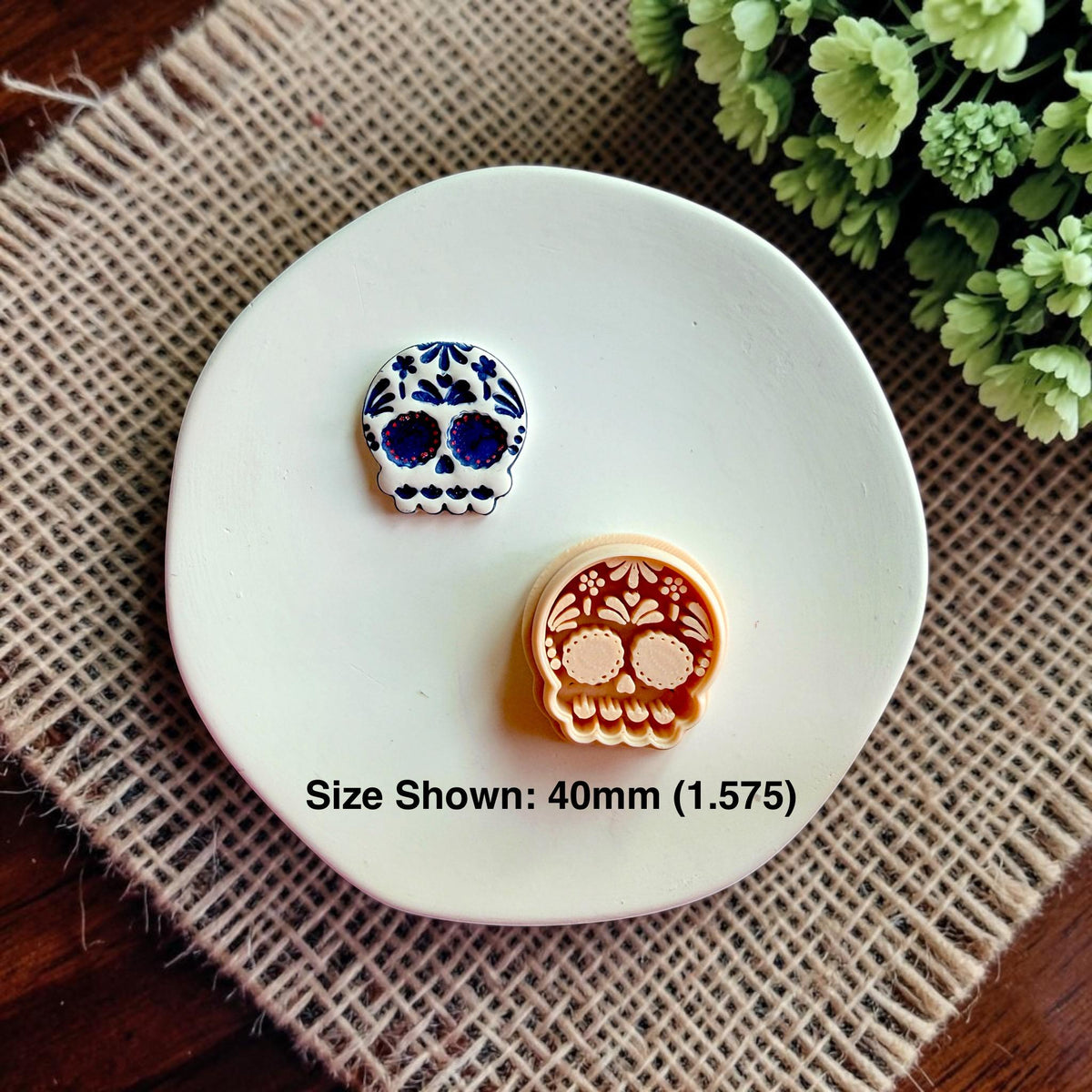Finished clay earring beside Sugar Skull polymer clay cutter for size comparison.