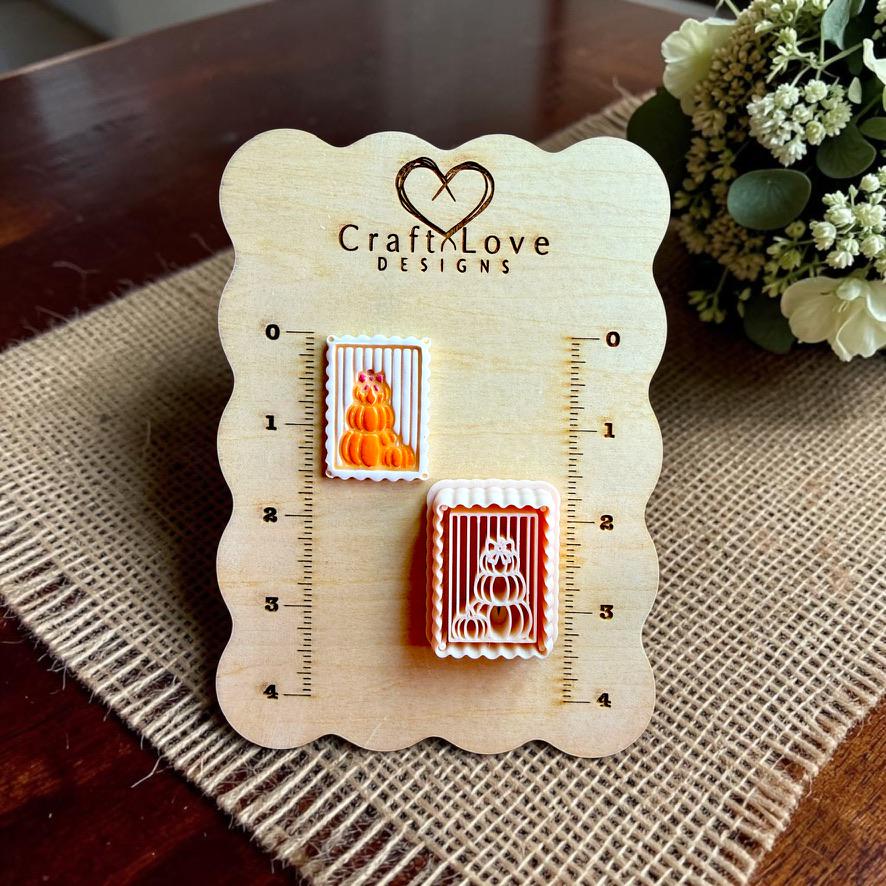 Finished stacked pumpkin clay design and matching polymer clay cutter displayed on a Craft Love Designs size board.