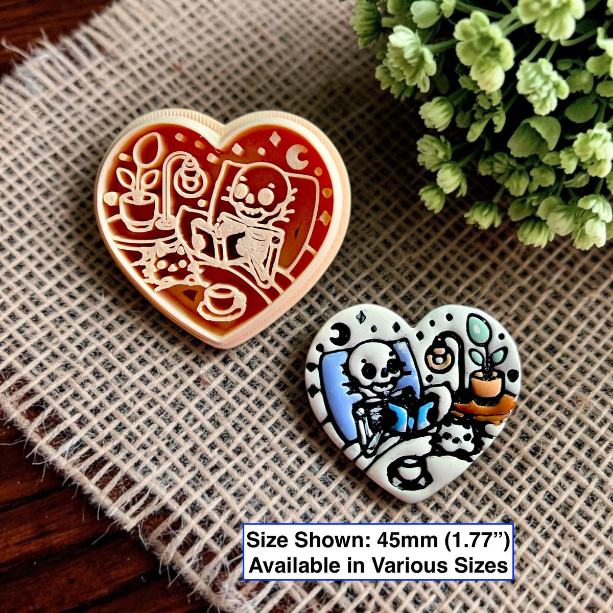 Finished polymer clay heart showing a reading skeleton next to the matching heart-shaped cutter with size information.