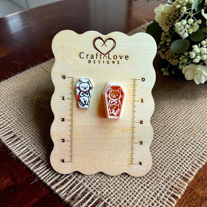 Vampire cat polymer clay cutter displayed beside a finished coffin-shaped clay piece on a Craft Love Designs sizing board.