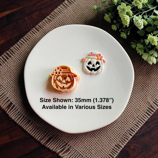 Harvest pumpkin polymer clay cutter displayed beside finished jack o lantern clay earring showing the detailed impression for autumn jewelry making.