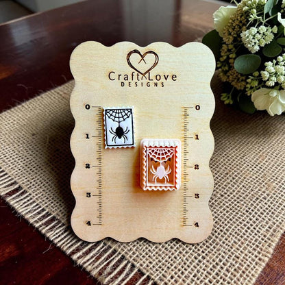 Finished spider web clay piece and matching polymer clay cutter displayed on a Craft Love Designs size board.