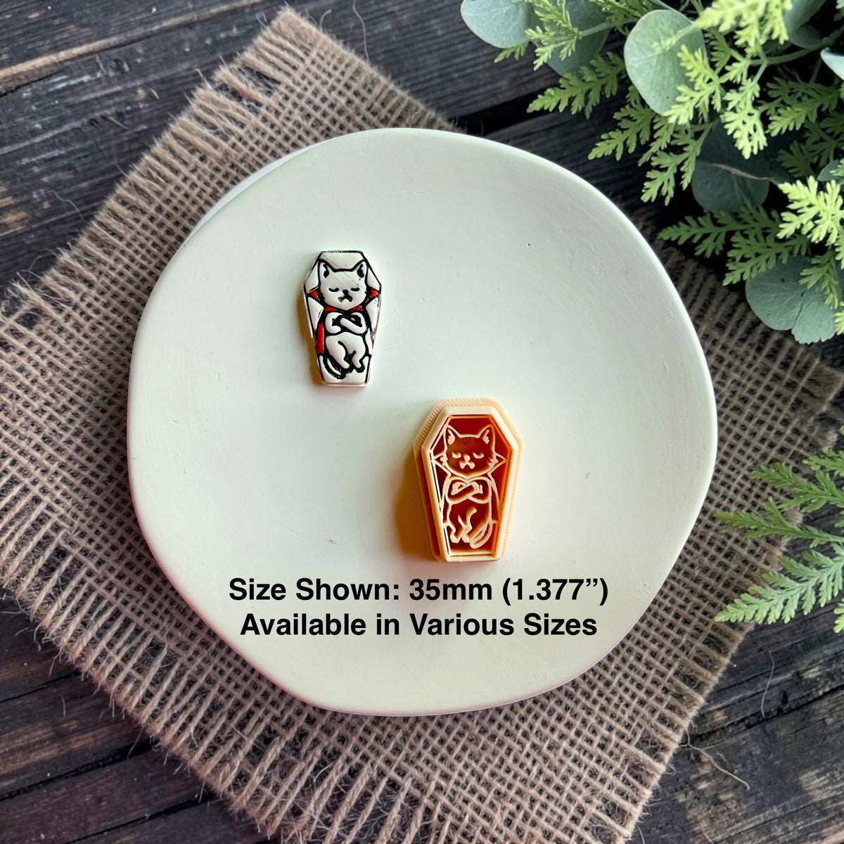 Finished vampire cat polymer clay piece displayed next to the matching cutter with size information.