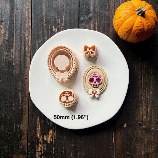 Sugar skull, bow, and ornate oval frame pieces displayed beside a finished layered example with a pink skull, cream frame, and white bow; text on the image shows 50mm (1.96 inches).