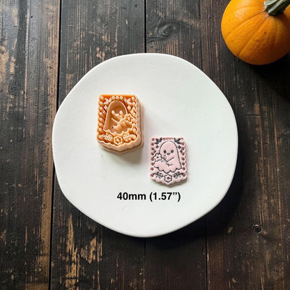Peach floral ghost design beside a finished pale pink clay example with dark detailing on a white plate; text below shows the size as 40mm or 1.57 inches.