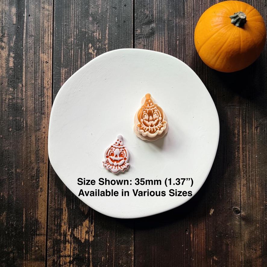 Finished vintage clown pumpkin clay piece beside the peach-colored matching design, with text stating size shown is 35mm (1.37") and available in various sizes.