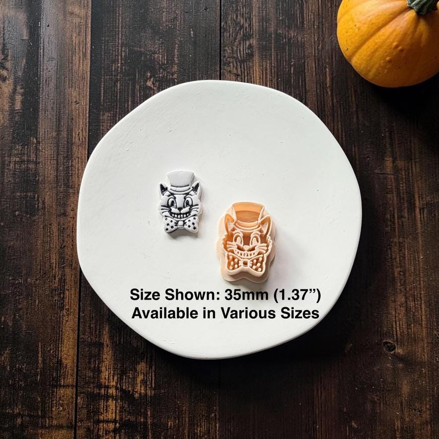 Finished white and black vintage Halloween cat beside the matching peach-colored design, showing the top hat, grinning face, whiskers, and polka-dot bow tie; text states 35mm (1.37") and available in various sizes.