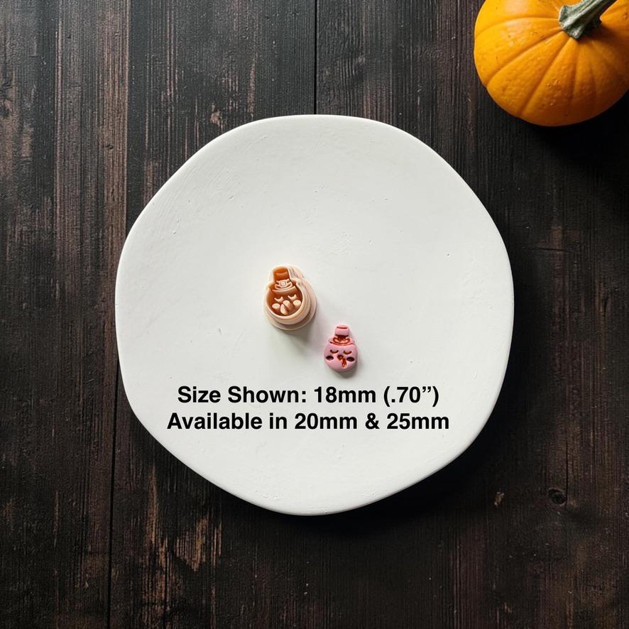 Peach-colored turkey design wearing a small pilgrim-style hat beside a finished pink turkey example on a white round surface; text states size shown 18mm (.70") and available in 20mm and 25mm.