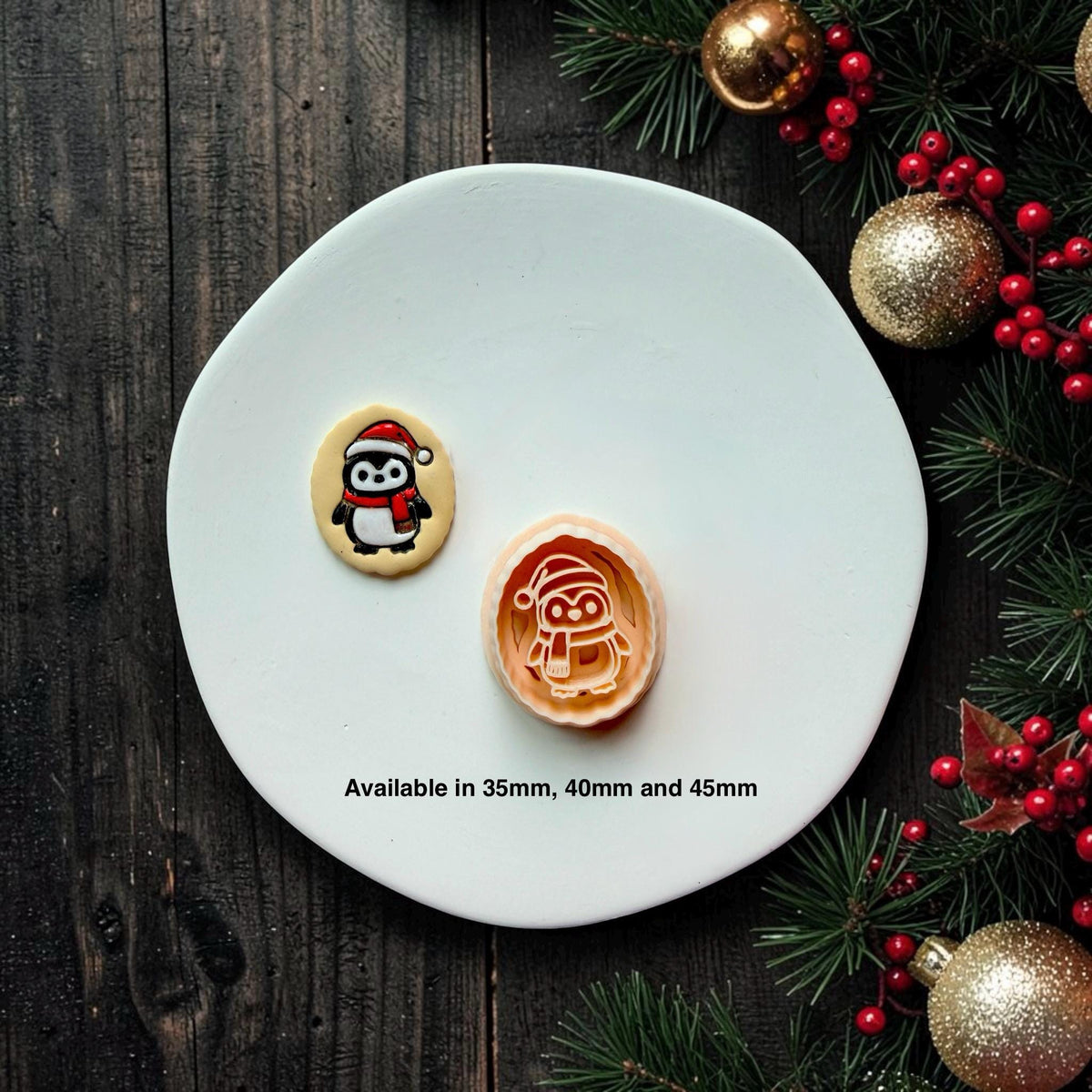 Finished black, white, and red Christmas penguin piece beside the matching larger design on a white plate, with text showing available sizes of 35mm, 40mm, and 45mm.