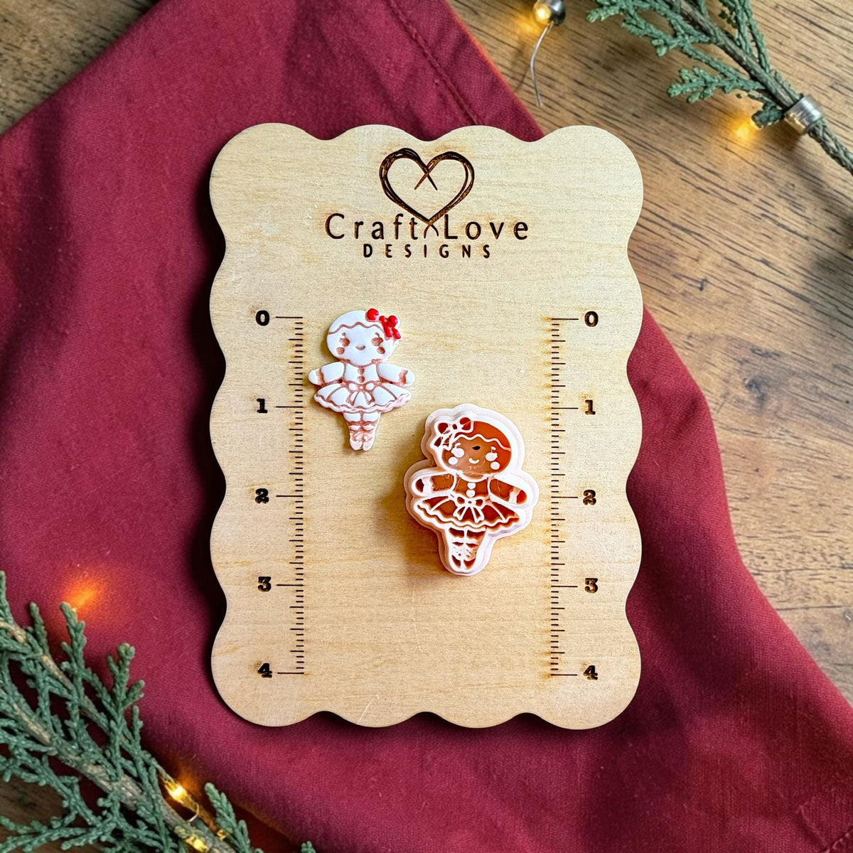 Gingerbread ballerina polymer clay cutter and finished white gingerbread ballerina clay piece displayed on a wooden Craft Love Designs sizing board with inch measurements.