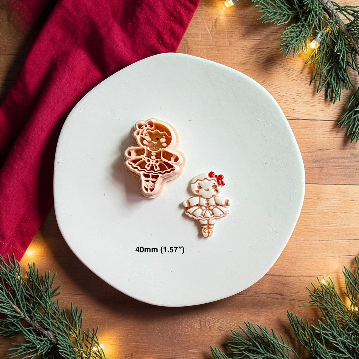 Gingerbread ballerina polymer clay cutter beside the finished white and brown ballerina clay piece on a white plate with text showing the 40mm or 1.57 inch size.