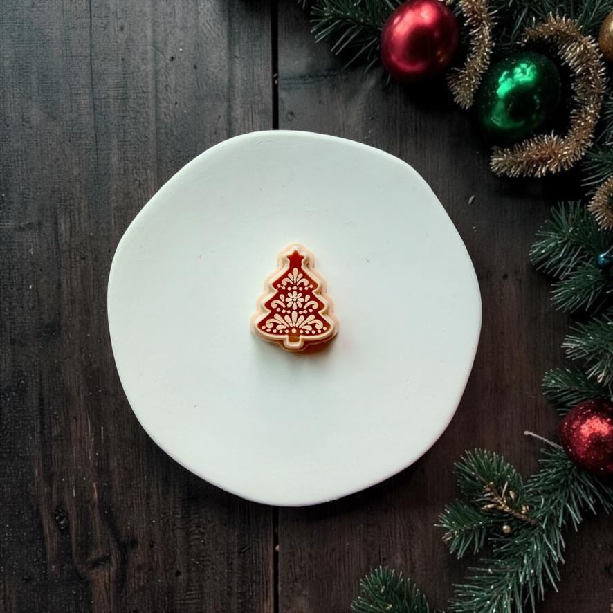 Large red and cream folk art Christmas tree design centered on a white surface. The Christmas tree features a star topper and detailed floral and botanical ornamentation, surrounded by festive greenery and ornaments.